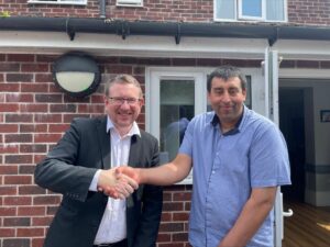 Andrew Gwynne MP and Tauseef shaking hands on the Minister's visit to the social care service in Stockport.