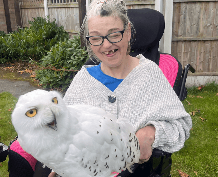 Tracy with a big smile on her face, whilst holding the snowy owl.